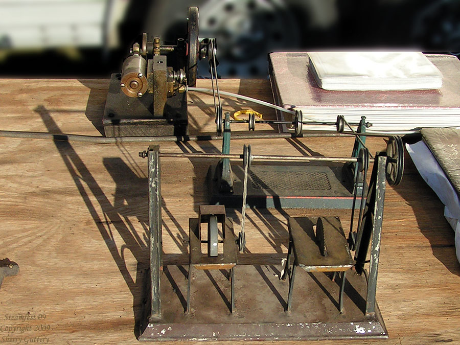 Engines in the outdoor area - model engine powering a model table saw and model grinding wheel.  Soule Live Steam Festival Meridian, MS 2009